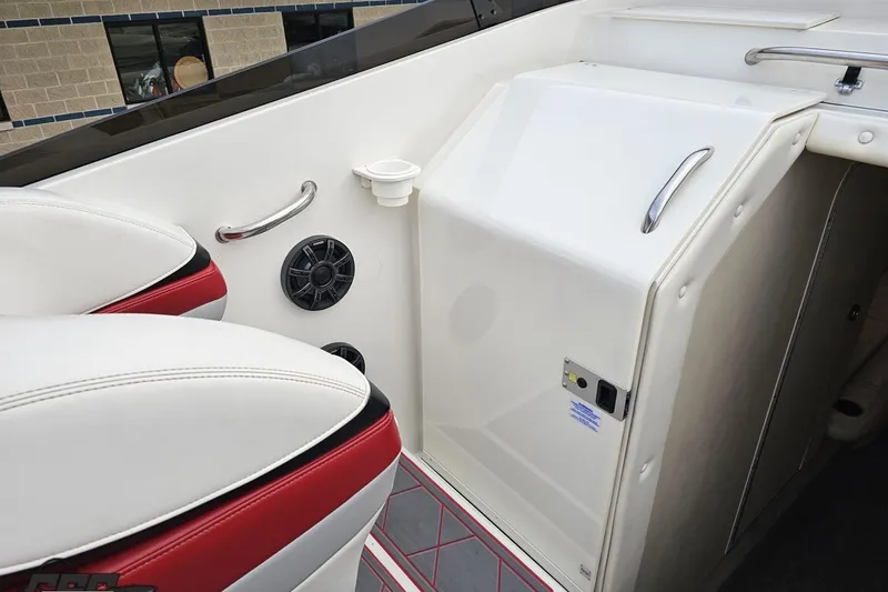 Slide: The Image of Interior of 2004 Black Thunder 460 boat with white and red seating, speaker, and cup holder. - 53