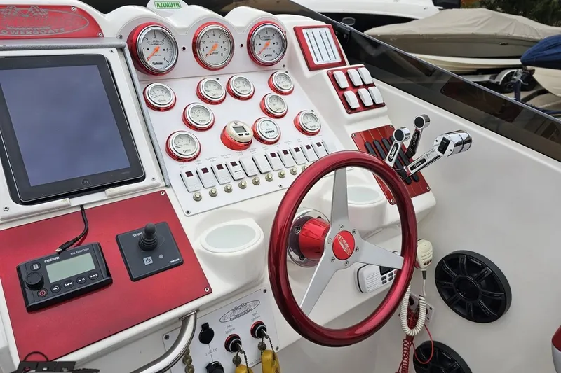 Slide: The Image of Dashboard of a 2004 Black Thunder 460 boat with gauges and controls. - 54