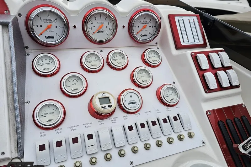 Slide: The Image of Dashboard of a 2004 Black Thunder 460 boat with gauges and switches. - 58