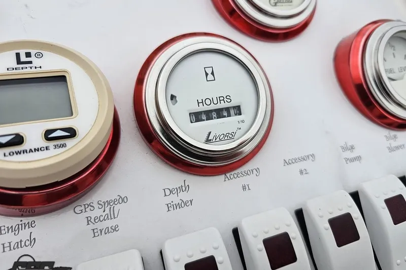 Slide: The Image of Dashboard of a 2004 Black Thunder 460 boat with gauges and switches. - 59