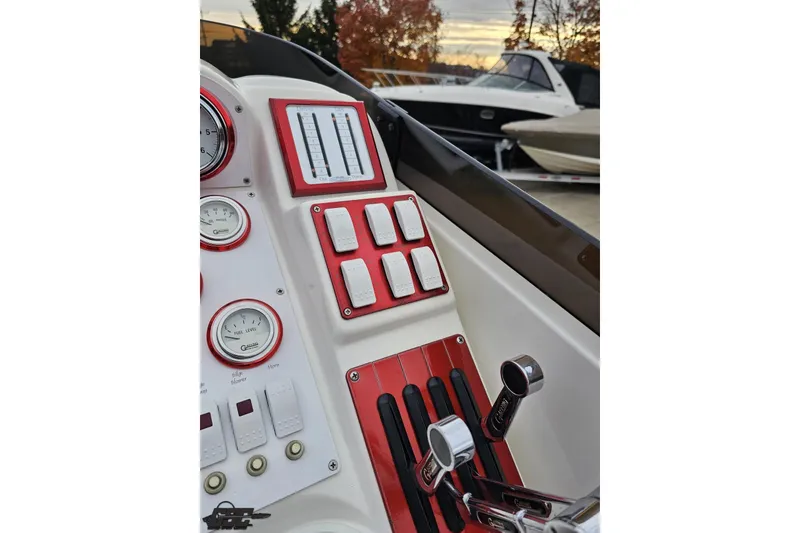 Slide: The Image of Dashboard of 2004 Black Thunder 460 boat with gauges and controls, outdoor setting. - 60