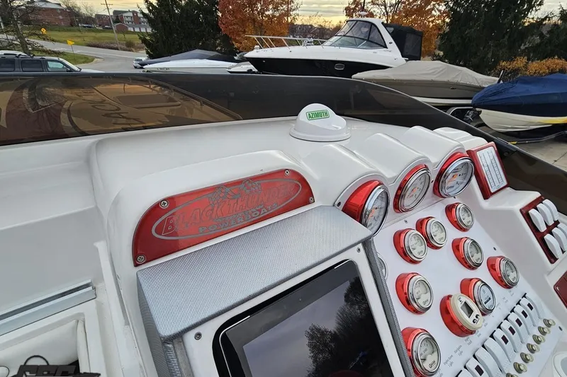 Slide: The Image of Dashboard of a 2004 Black Thunder 460 powerboat with gauges and controls. - 62