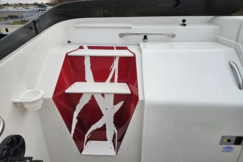 Slide: The Image of 2004 Black Thunder 460 boat with red and white steps and stainless steel handles. - 63