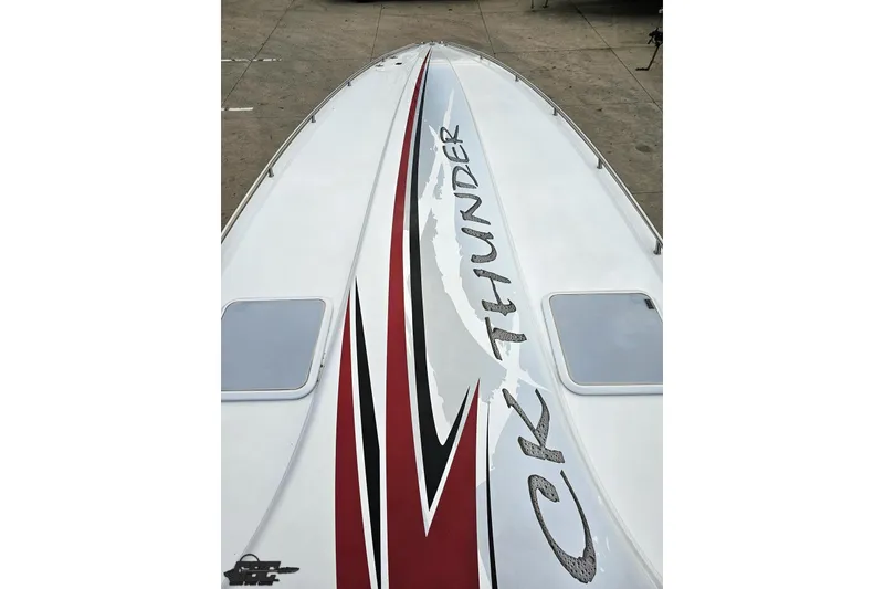 Slide: The Image of 2004 Black Thunder 460 boat with sleek design and bold graphics on deck. - 65