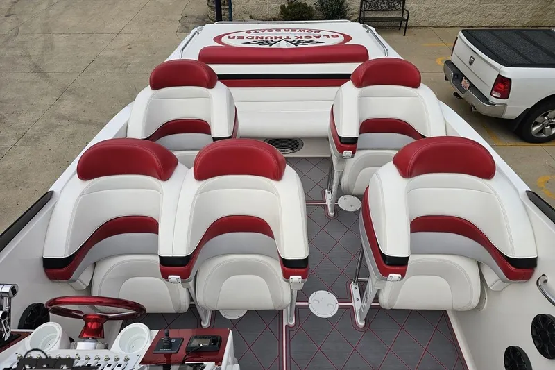 Slide: The Image of Interior of 2004 Black Thunder 460 boat with red and white seating arrangement. - 68