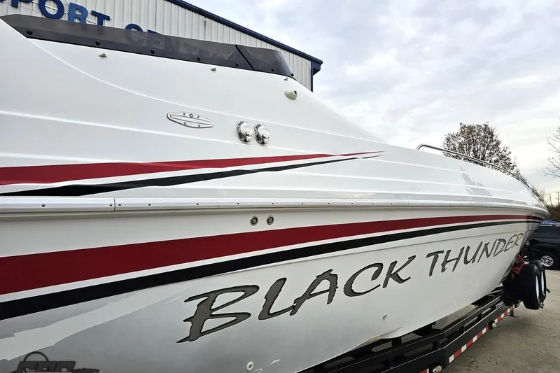Slide: The Image of 2004 Black Thunder 460 boat with sleek design and bold graphics. - 7
