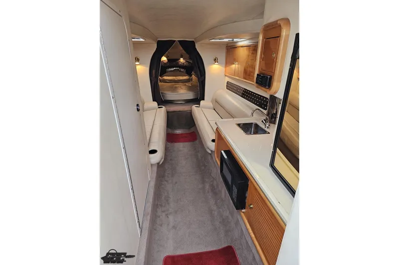 Slide: The Image of Luxurious interior of a 2004 Black Thunder 460 boat, featuring seating, kitchenette, and cozy sleeping area. - 71