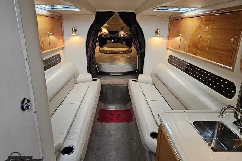 Slide: The Image of Luxurious interior of a 2004 Black Thunder 460 boat with white leather seating. - 72