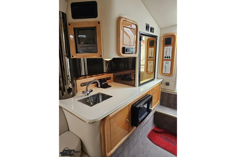Slide: The Image of Interior of 2004 Black Thunder 460 boat featuring a compact kitchen area. - 74