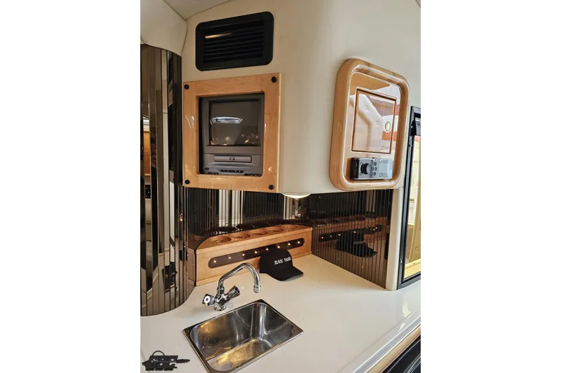 Slide: The Image of 2004 Black Thunder 460 interior with sink, TV, and control panel. - 75