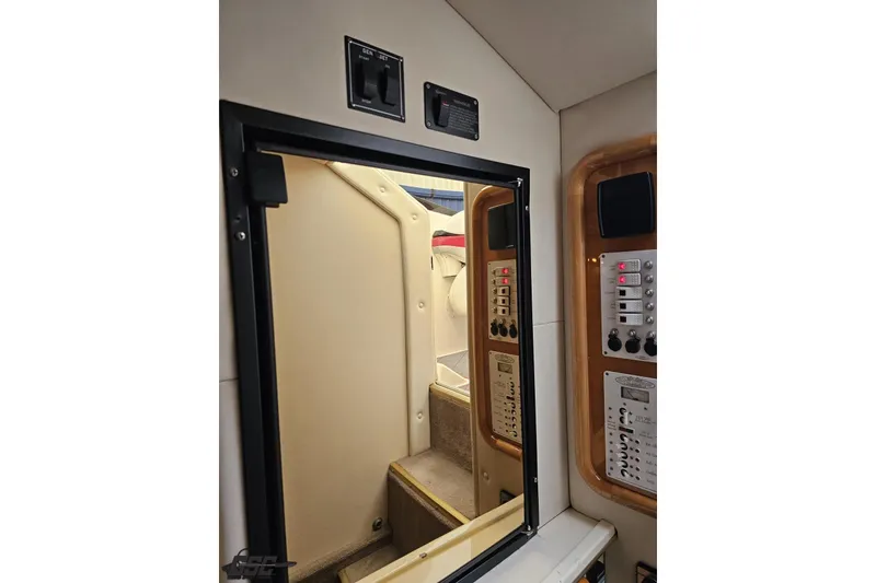 Slide: The Image of Interior view of 2004 Black Thunder 460 boat cabin with control panels and steps. - 78