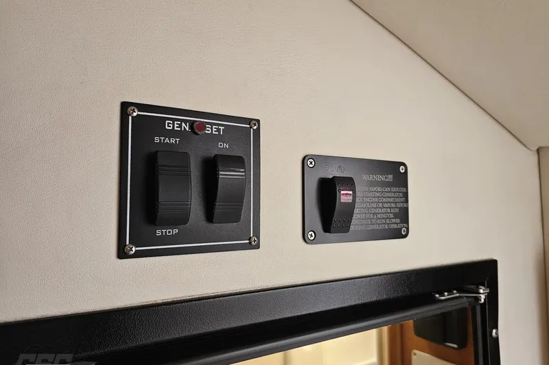 Slide: The Image of Control panel of a 2004 Black Thunder 460 boat with generator switches. - 79