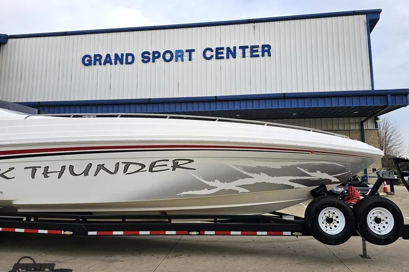 Slide: The Image of 2004 Black Thunder 460 boat at Grand Sport Center, displayed on a trailer. - 8