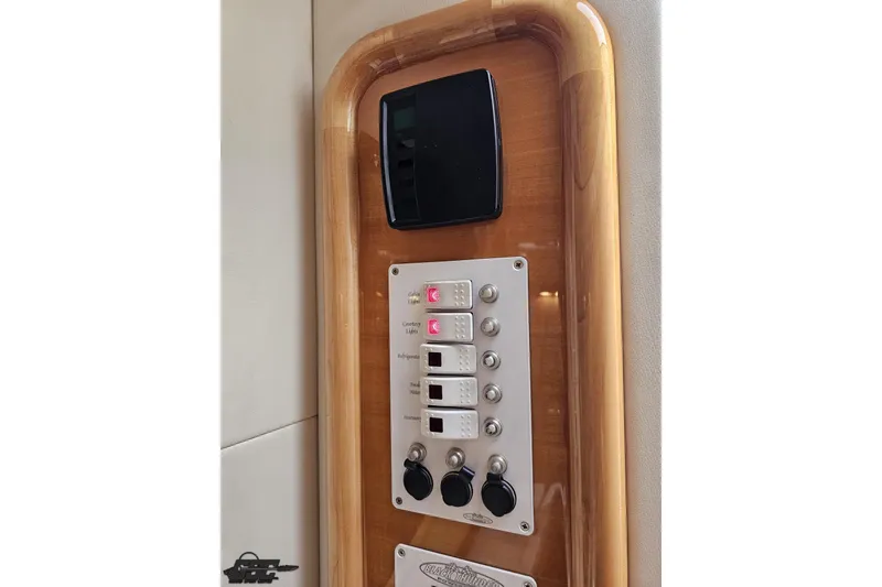 Slide: The Image of Control panel of a 2004 Black Thunder 460 boat with wood trim. - 80