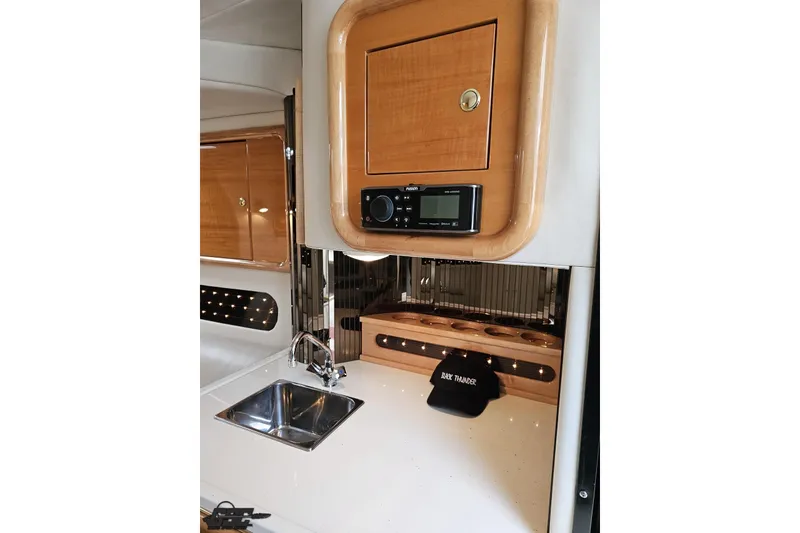 Slide: The Image of Interior of 2004 Black Thunder 460 boat with wood cabinetry and sink. - 81