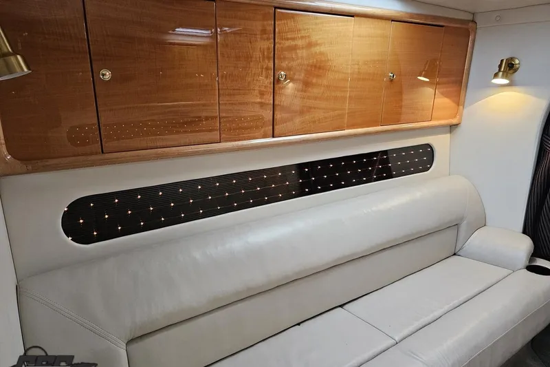 Slide: The Image of Luxurious interior of 2004 Black Thunder 460 with leather seating and wooden cabinets. - 83