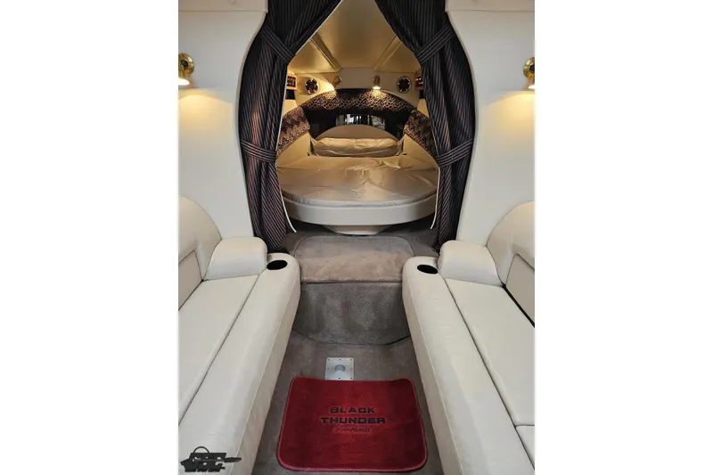 Slide: The Image of Luxurious interior of a 2004 Black Thunder 460 boat with plush seating and cozy sleeping area. - 84