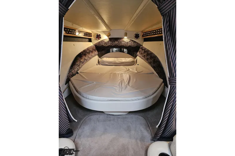 Slide: The Image of Luxurious interior cabin of 2004 Black Thunder 460 boat with cozy bedding and elegant design. - 85