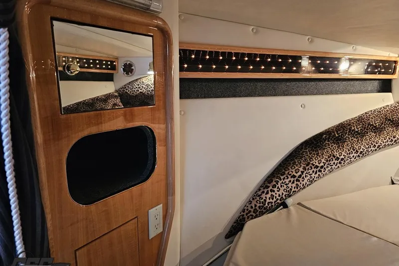 Slide: The Image of 2004 Black Thunder 460 cabin interior with wood paneling and leopard print accents. - 86