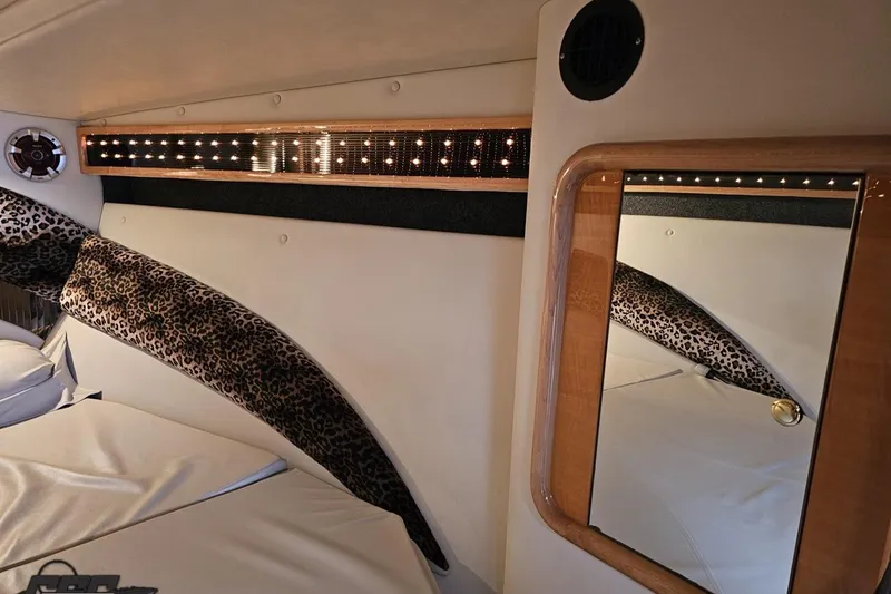 Slide: The Image of Interior of 2004 Black Thunder 460 boat with leopard print accents and mirror. - 87