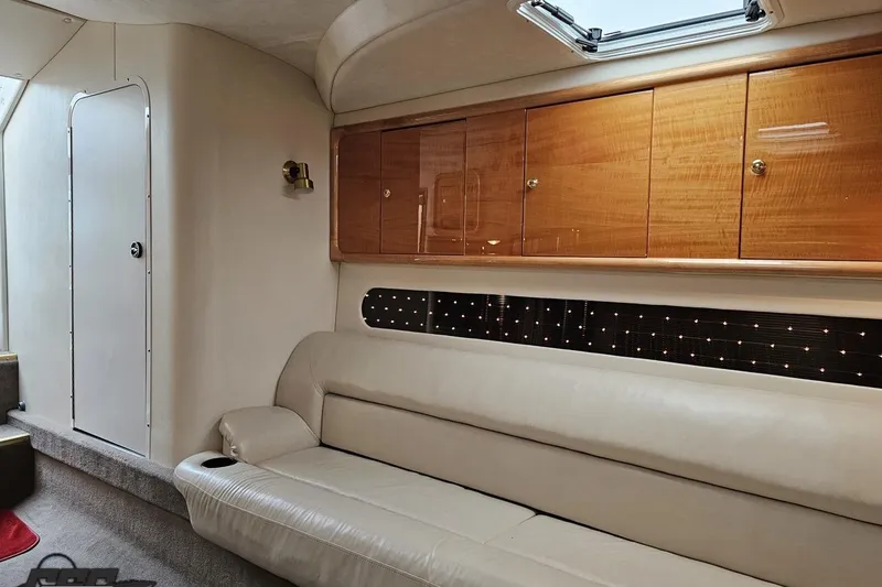 Slide: The Image of Luxurious interior of 2004 Black Thunder 460 boat with leather seating and wooden cabinets. - 88