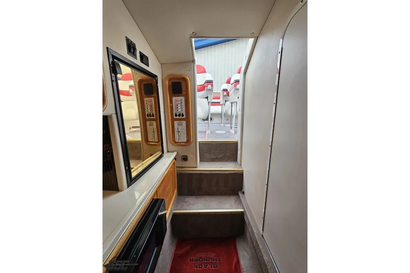 Slide: The Image of Interior view of 2004 Black Thunder 460 boat, featuring steps and control panels. - 89