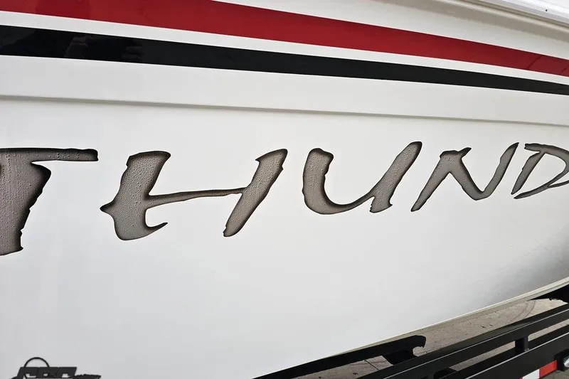 Slide: The Image of Close-up of 2004 Black Thunder 460 boat with bold 'Thunder' lettering. - 9