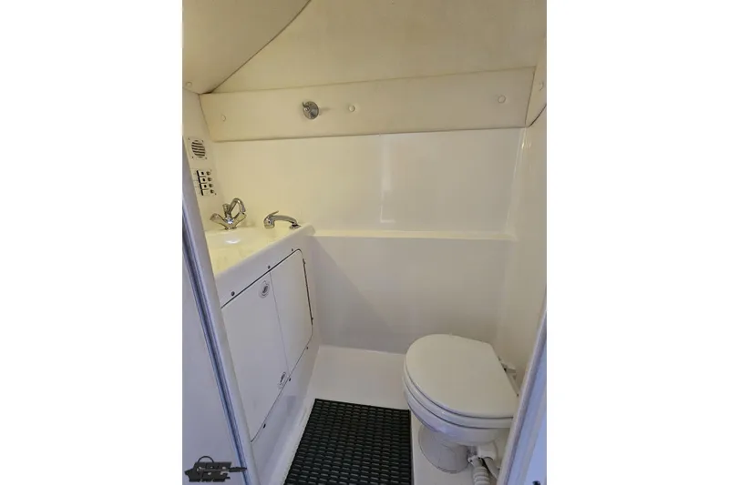 Slide: The Image of Compact bathroom in 2004 Black Thunder 460 boat with sink and toilet. - 90