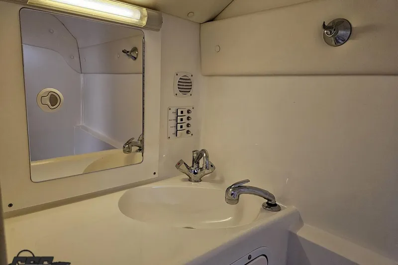 Slide: The Image of Bathroom interior of 2004 Black Thunder 460 boat with sink and mirror. - 92
