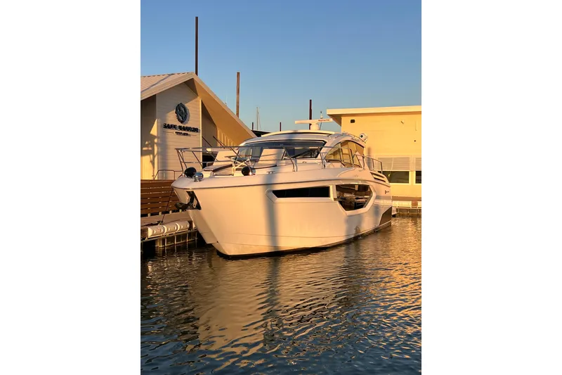 Slide: The Image of 2019 Cruisers Yachts 42 Cantius docked at sunset near marina building. - 122