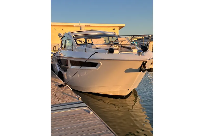 Slide: The Image of 2019 Cruisers Yachts 42 Cantius docked at sunset, reflecting on water. - 123