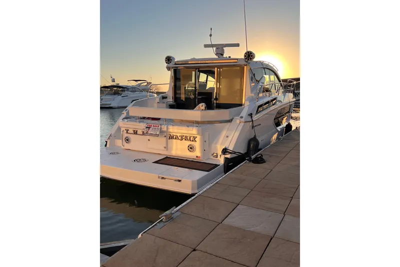 Slide: The Image of 2019 Cruisers Yachts 42 Cantius docked at sunset, rear view. - 125