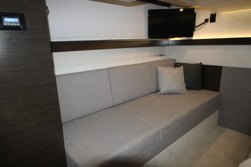 Slide: The Image of Interior of 2019 Cruisers Yachts 42 Cantius with gray sofa and mounted TV. - 37