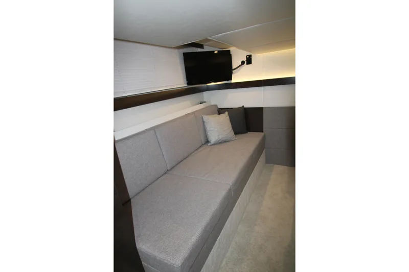 Slide: The Image of 2019 Cruisers Yachts 42 Cantius interior with gray sofa and wall-mounted TV. - 39