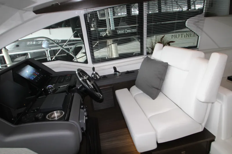 Slide: The Image of Interior of 2019 Cruisers Yachts 42 Cantius with modern helm and white seating. - 54