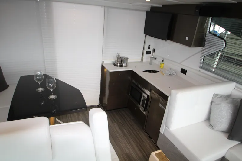 Slide: The Image of 2019 Cruisers Yachts 42 Cantius interior with modern kitchen and dining area. - 56