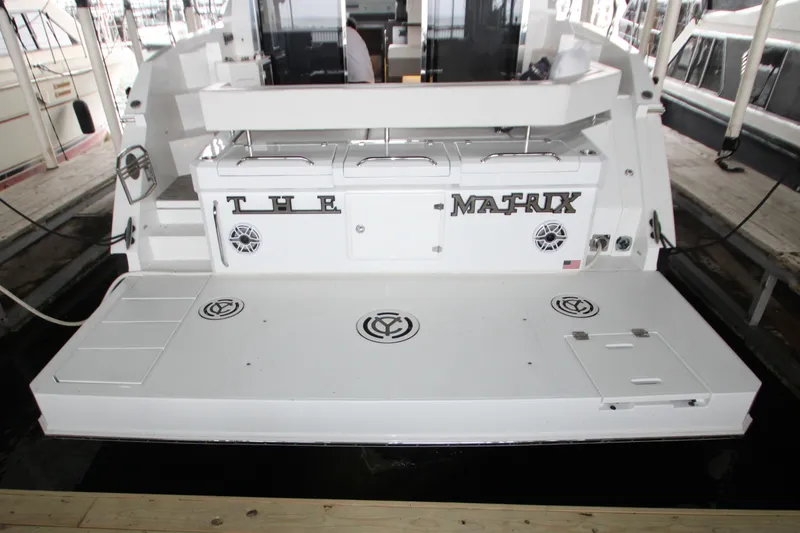 Slide: The Image of 2019 Cruisers Yachts 42 Cantius, rear view with "The Matrix" nameplate at dock. - 82