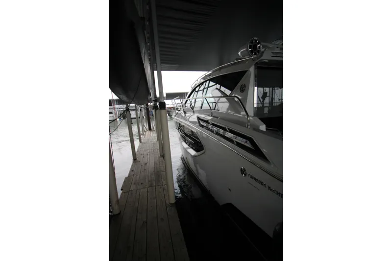 Slide: The Image of 2019 Cruisers Yachts 42 Cantius docked under a covered marina. - 105