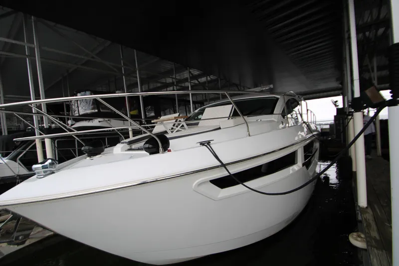 Slide: The Image of 2019 Cruisers Yachts 42 Cantius docked in a covered marina. - 109