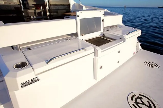 Slide: The Image of Manufacturer Provided Image: 2019 Cruisers Yachts 42 Cantius, rear deck view with storage compartments and ocean backdrop. - 115