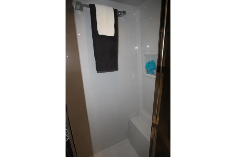 Slide: The Image of 2019 Cruisers Yachts 42 Cantius shower area with towels and storage shelf. - 29
