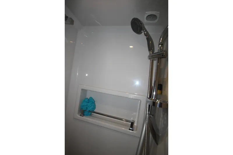 Slide: The Image of Shower area in 2019 Cruisers Yachts 42 Cantius with chrome fixtures and blue bath sponge. - 30