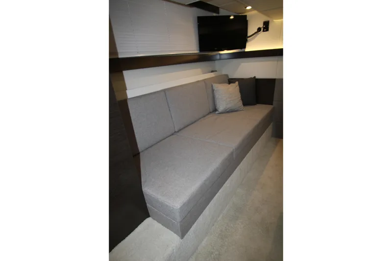 Slide: The Image of 2019 Cruisers Yachts 42 Cantius interior with gray sofa and wall-mounted TV. - 38