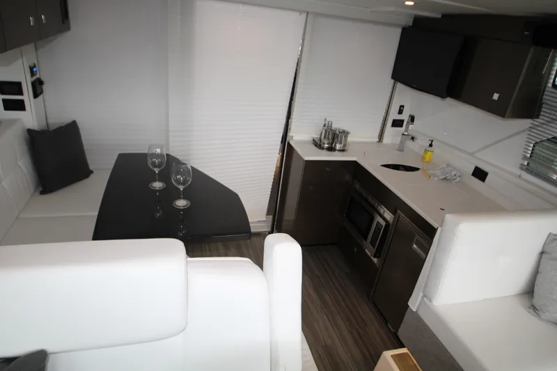 Slide: The Image of Interior of 2019 Cruisers Yachts 42 Cantius with modern kitchen and dining area. - 57