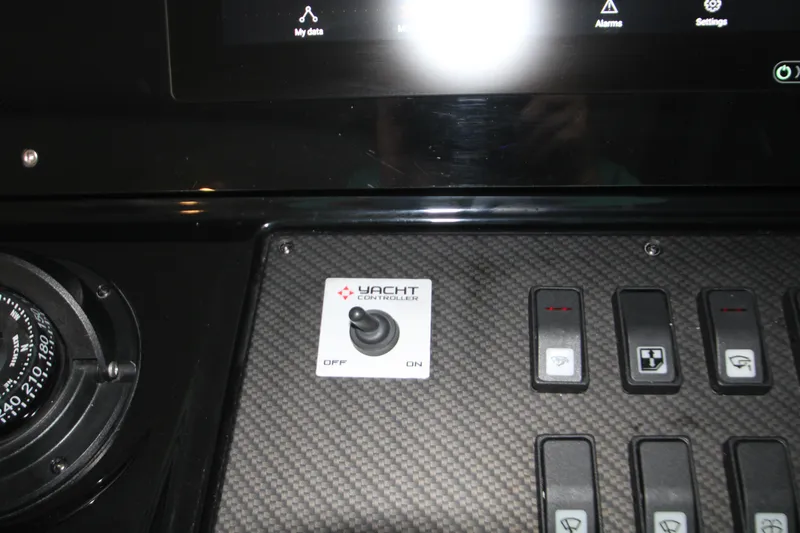 Slide: The Image of Control panel of 2019 Cruisers Yachts 42 Cantius with switches and compass. - 66
