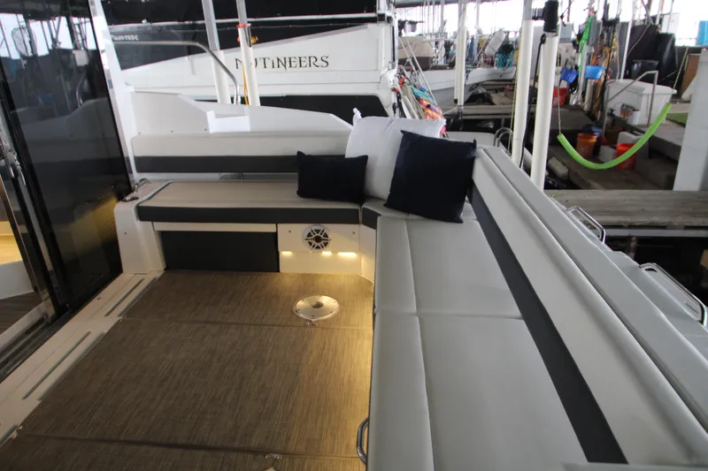 Slide: The Image of 2019 Cruisers Yachts 42 Cantius cockpit with cushioned seating and decorative pillows. - 84