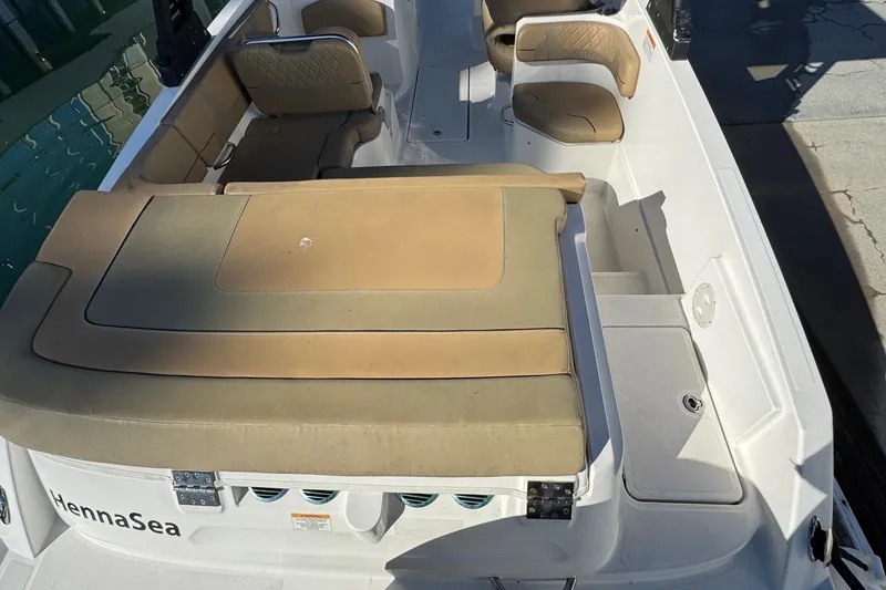 Slide: The Image of 2022 Bayliner VR6 Bowrider OB docked, showcasing outboard motor and spacious seating. - 13