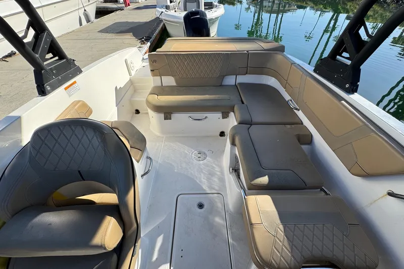 Slide: The Image of 2022 Bayliner VR6 Bowrider OB interior with beige seating and modern dashboard. - 18
