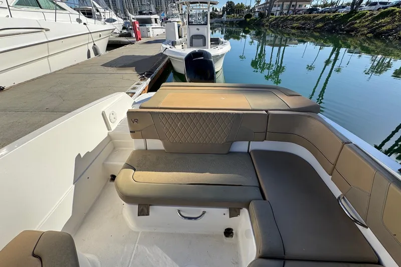 Slide: The Image of 2022 Bayliner VR6 Bowrider OB interior with tan seating and modern design. - 19