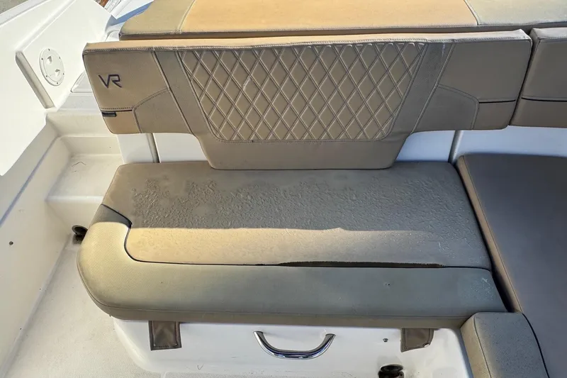 Slide: The Image of 2022 Bayliner VR6 Bowrider OB interior with tan seating and steering console. - 20